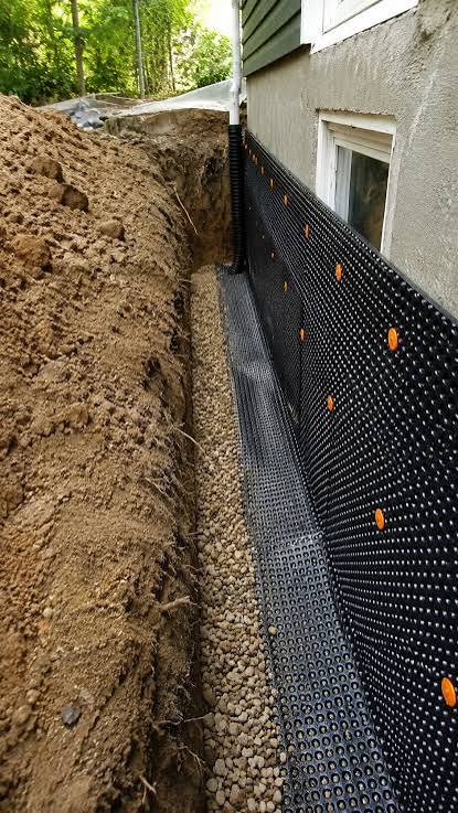 Exterior foundation waterproofing membrane beside an excavation
